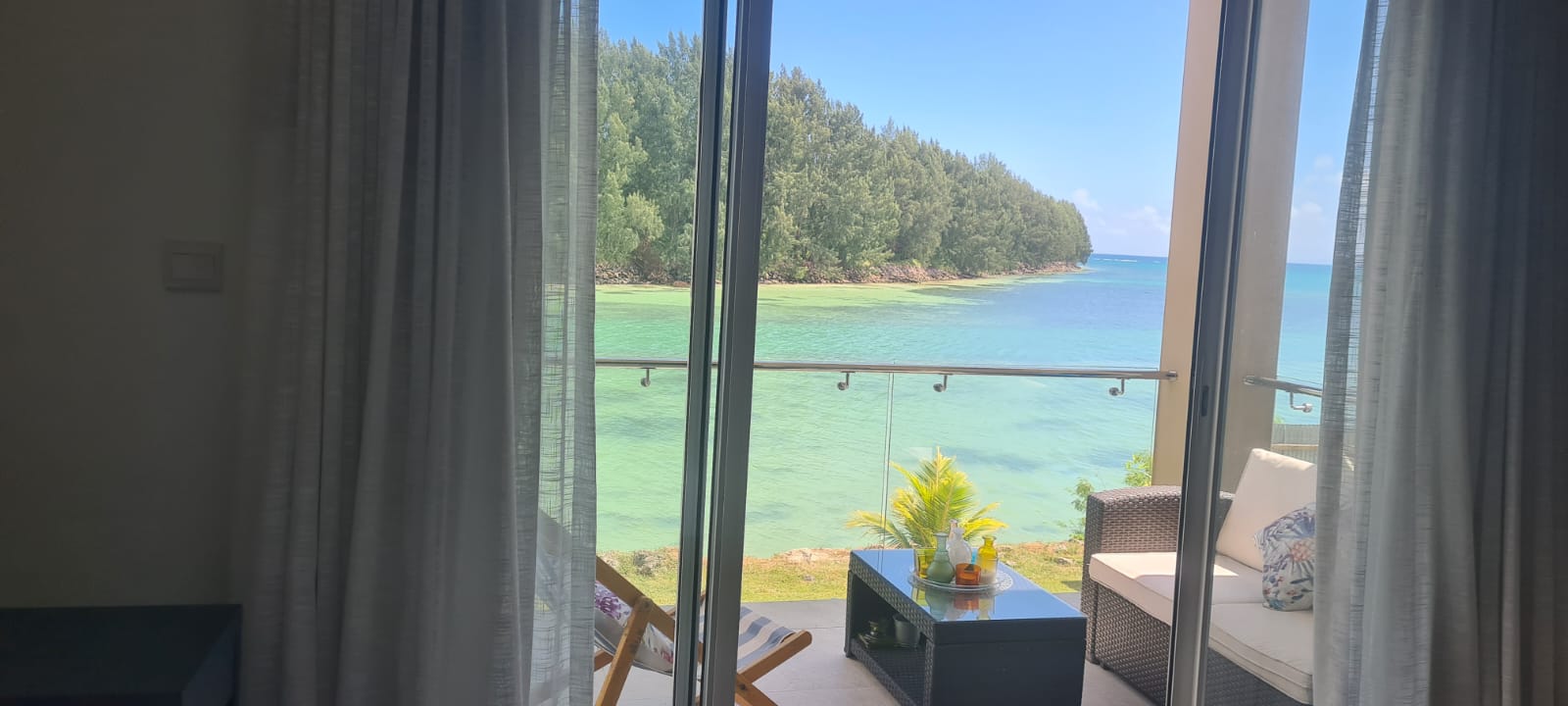 Turquoise sea viewed through the balcony doors